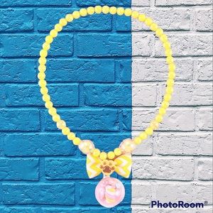 Yellow beaded necklace with ball pendant for girls.